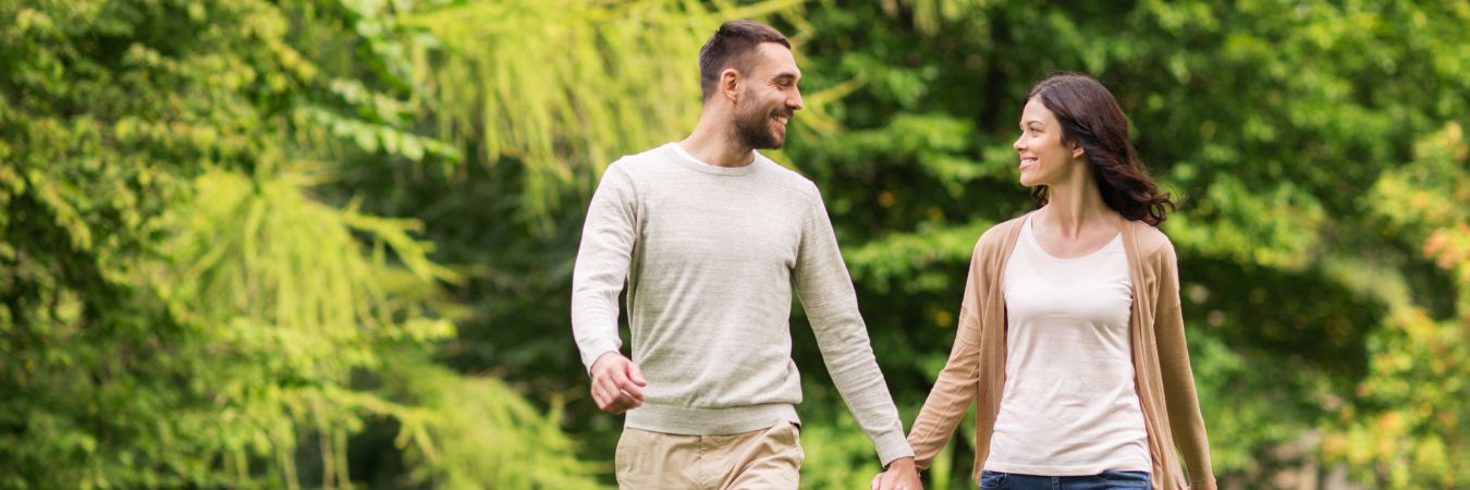  A couple walking hand in hand at a park during summer season enjoying life after rehab in Fair Lawn